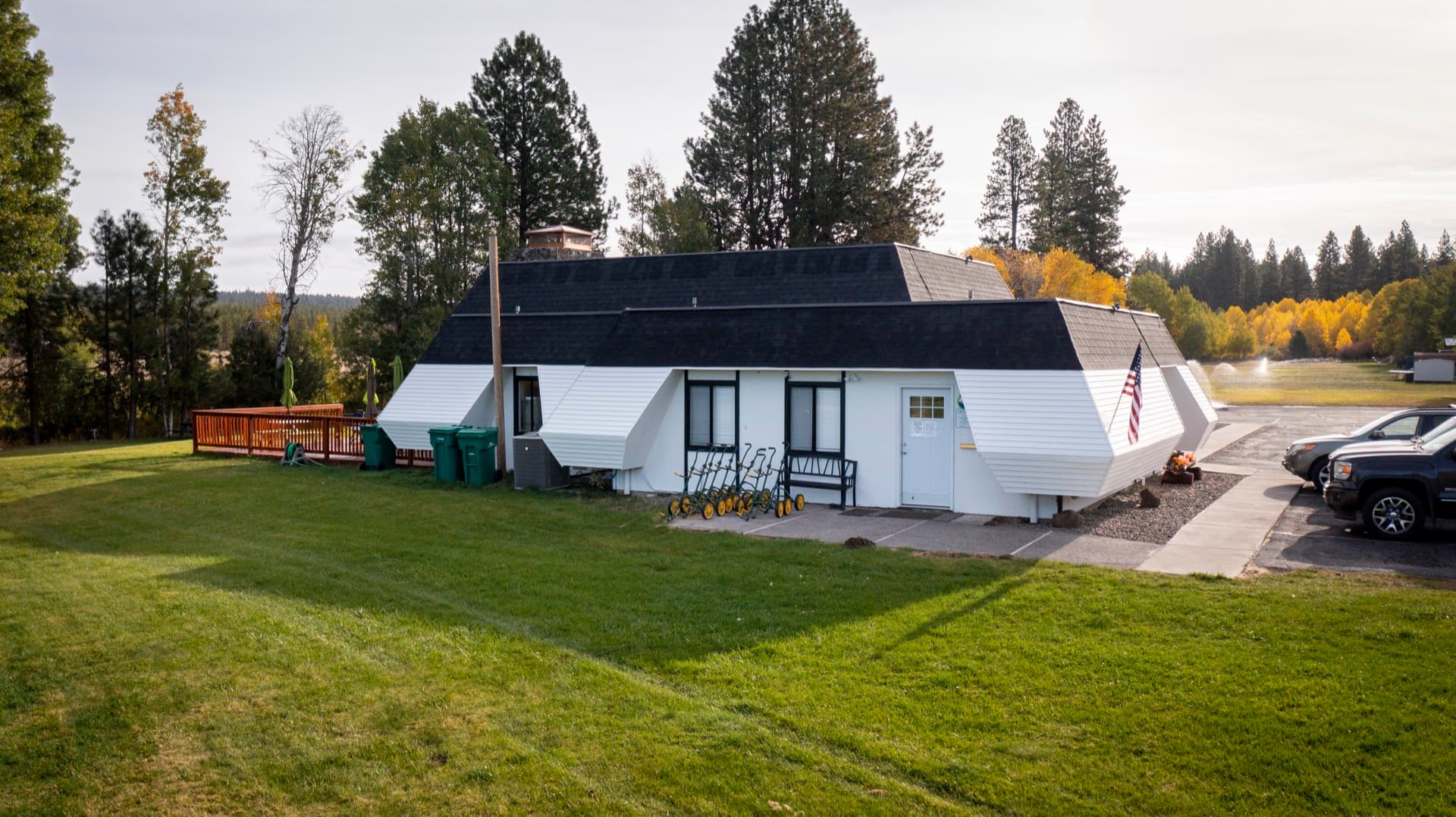 Round Lake Community golf clubhouse exterior with pull carts and fall foliage