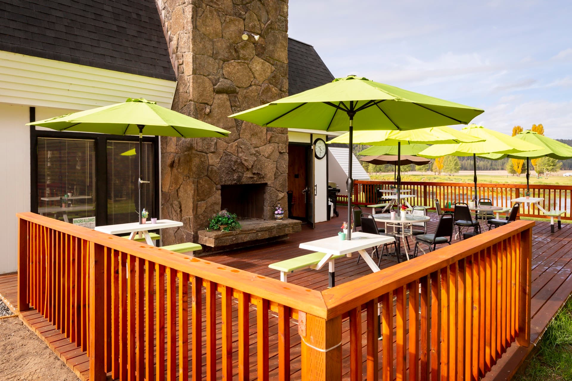 Clubhouse patio with stone fireplace and outdoor seating at Round Lake Community
