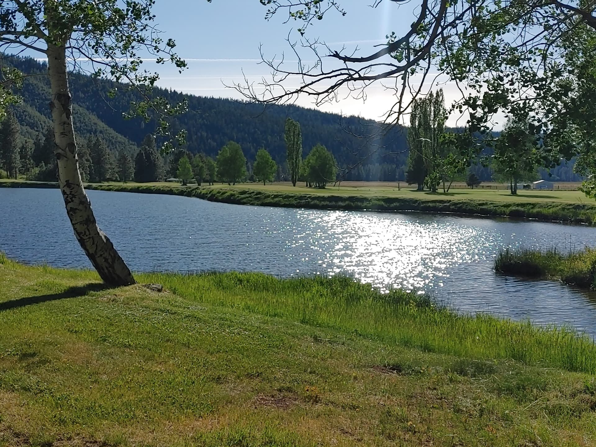 Scenic fishing pond at Round Lake Community with mountains and forest in Klamath Falls Oregon